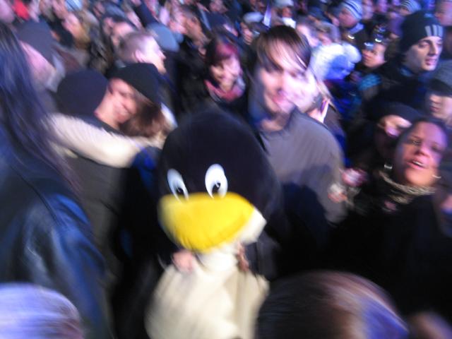 A 28C3 attendee with his giant plush Tux